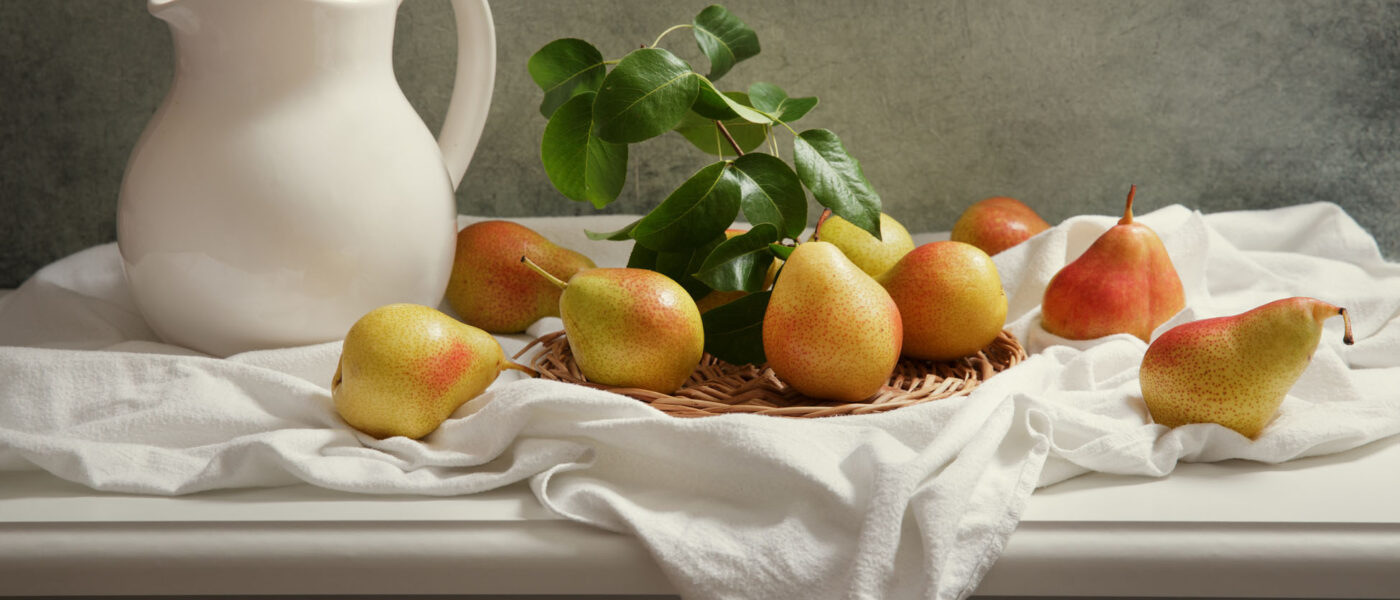 still life with fresh pears on wooden table still life with fresh pears with leaves on wooden table